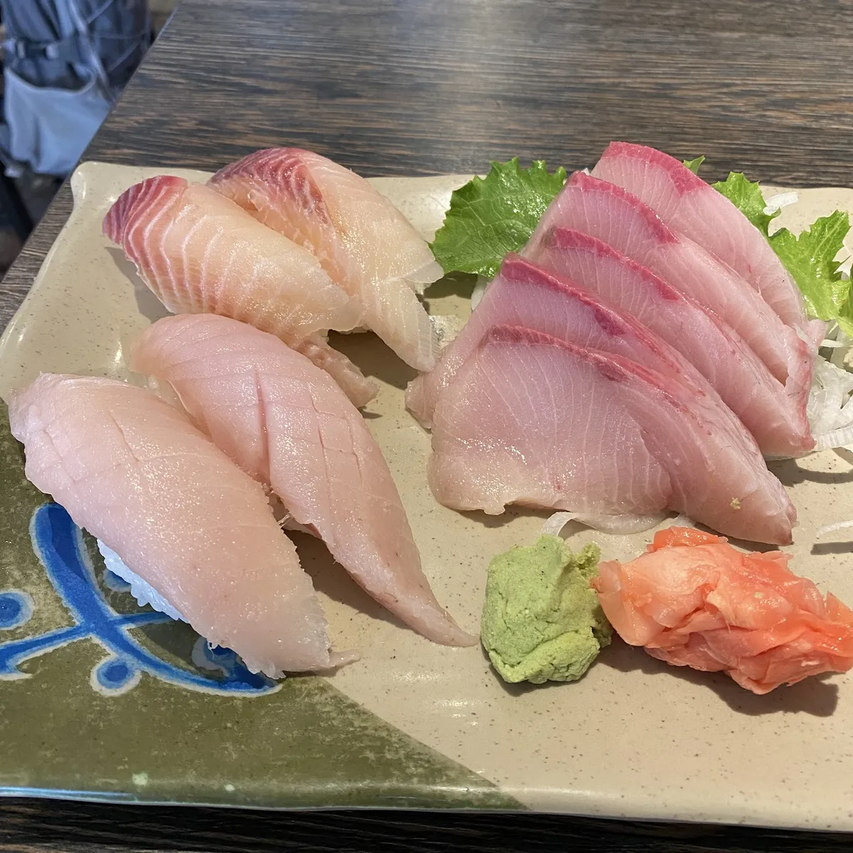 Plate of sushi and sashimi with wasabi and ginger